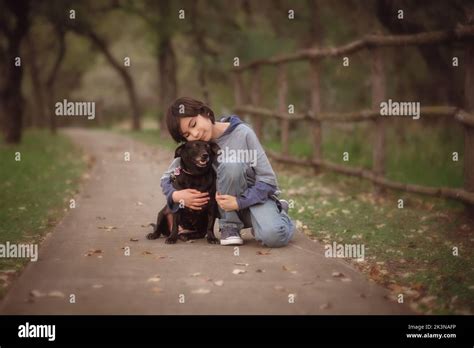 Boy Hugging Dog In Path Stock Photo Alamy