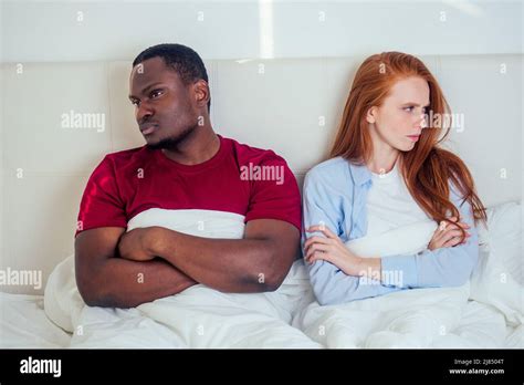 Afro Latin American Man And Redhaired Ginger Woman Ignoring Each Other