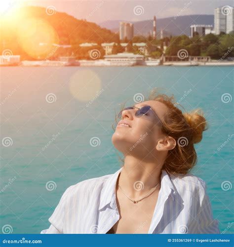 blonde girl in sunglasses in the sun on the background of the sea stock image image of blue