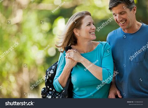 Happy Middle Aged Couple Walking Park Stock Photo Edit Now 1318604543
