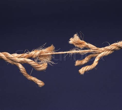 Frayed Rope About To Break Isolated On Blue Background Stock Photo