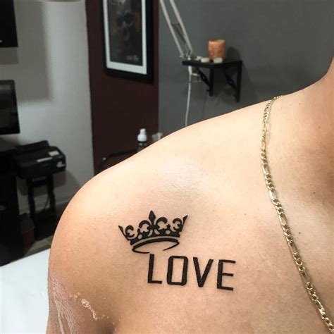 A Man With A Crown Tattoo On His Chest And The Word Love Written In