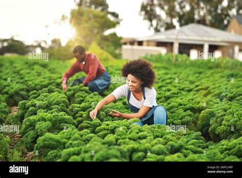 They love getting their hands dirty. a young farm couple working the