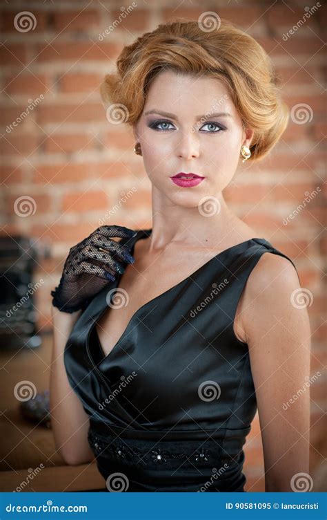 Young Beautiful Short Hair Blonde Woman In Black Dress Posing Elegant