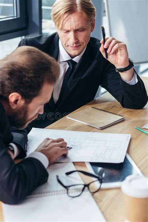 Concentrated Professional Businessmen Working Together Stock Image