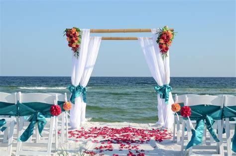 Looking to keep the budget on luckily, getting married in florida is a good idea just about any time of year, especially on the coast. cheap beach weddings Destin Florida, bamboo wedding arbor with flowers on the beach (With images ...