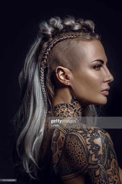 Side portrait of a tattooed viking blonde female and her unique