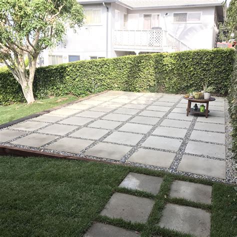 Laying pavers is a diy project that takes about one weekend to complete. Large pavers used to create patio in backyard. Quick and easy alternative to building a full ...