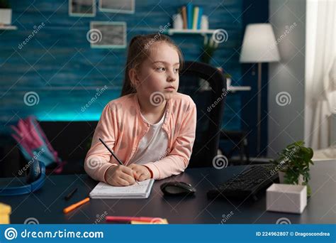 Little Kid Taking Notes On Class Notebook For Learning Stock Image