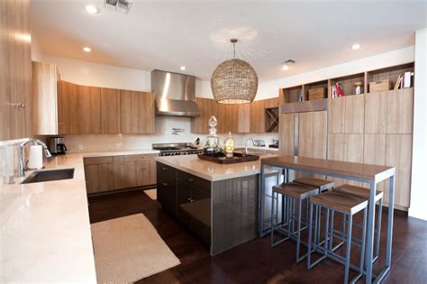 A varied tile backsplash and white cabinets were chosen to pair with the flooring, and overhead exposed beams featuring dark wood mirror what's below. 34 Kitchens with Dark Wood Floors (Pictures)