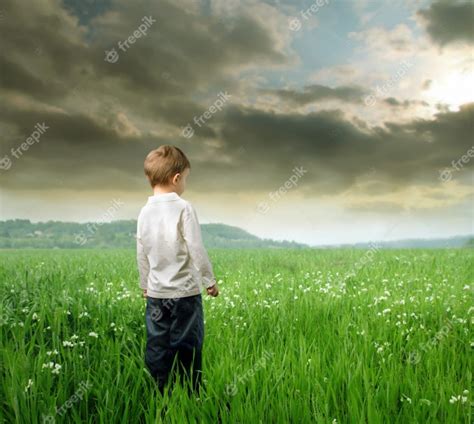 Premium Photo Little Boy Standing On A Field