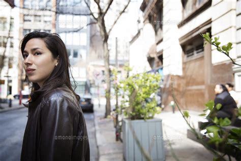 Side View Of Thoughtful Young Woman On City Street 11100039192 の写真素材
