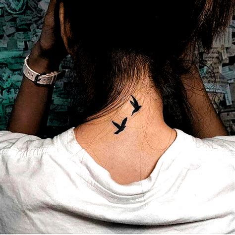 To Flying Birds Tattoo Inked On The Back Of The Neck Tattoosonneck