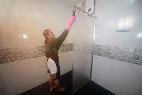 Asian Female Maid Or Housekeeper Cleaning On Toilet Partitions Stock