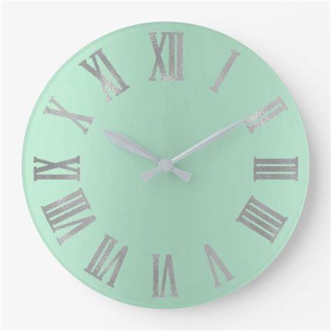 A Mint Green Clock With Roman Numerals On The Face And Numbers In Silver