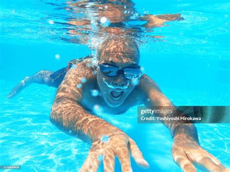 57 Year Old Man Swimming Underwater In Pool High Res Stock Photo