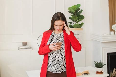 Premium Photo Businesswoman Looks Sadly At Her Mobile Phone