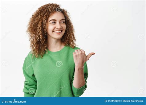Modern Beautiful Curly Girl Pointing And Looking At Right Side Showing Info And Smiling