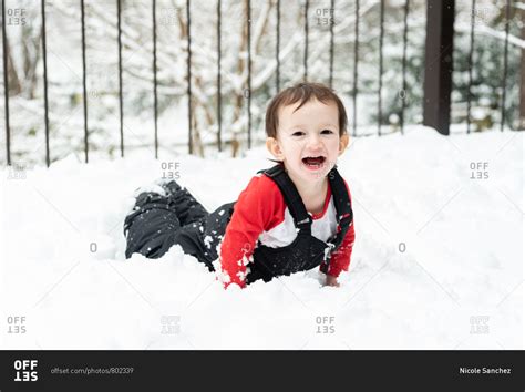 Happy Toddler Boy Playing In The Snow On A Snowy Deck Stock Photo Offset