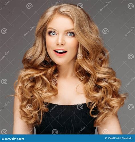 Blonde Woman With Curly Beautiful Hair Smiling On Gray Background