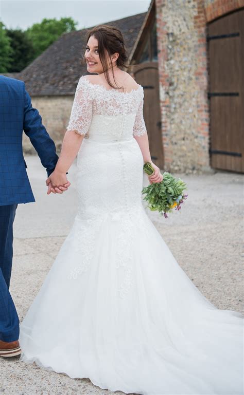 A marital dress, typically all white and decorated with frills and veils. White Rose Bridal Graceful Second Hand Wedding Dress on ...