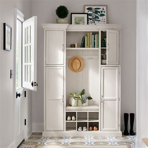 A White Classic Hall Tree With Cabinets Cubbies And Shelves In An