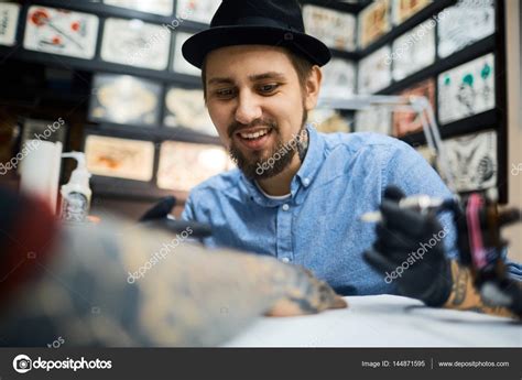 Tattoo Artist At Work Stock Photo By ©pressmaster 144871595