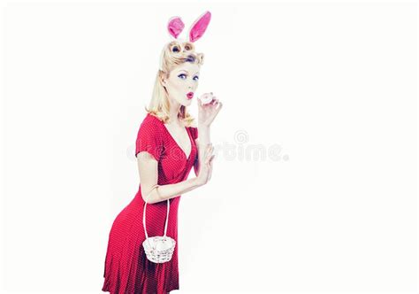 easter egg hunting woman wearing a mask easter bunny and looks very sensually happy easter