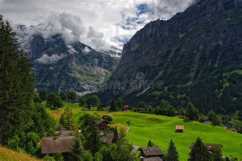 Alpine Landscape With Mountains Covered By Clouds In Grindelwald