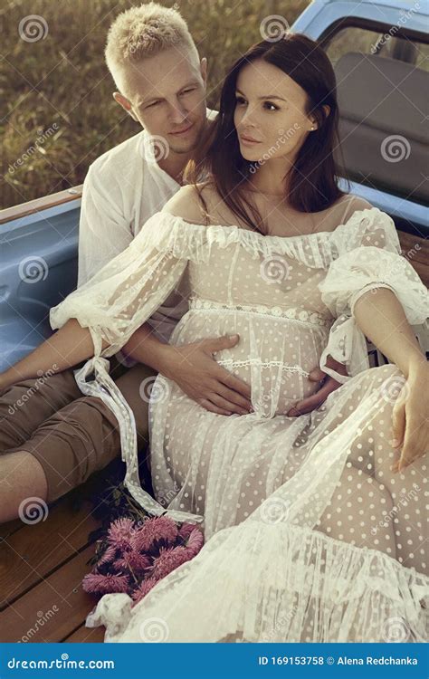 Pregnant Woman And Her Husband Happy Together And Looking Each Other With Love Outdoor