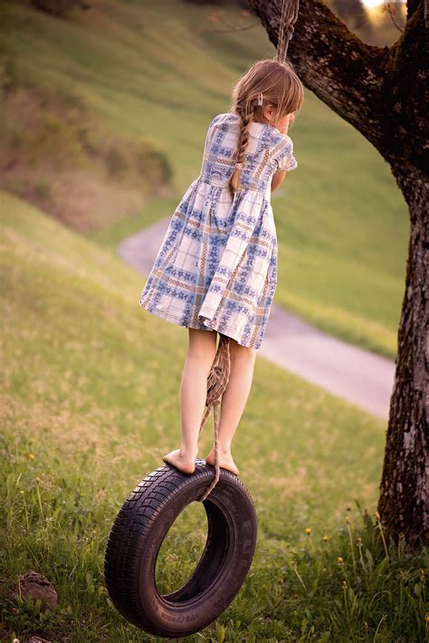 Girl Standing On Swing Tire Under Tree Hd Wallpaper Wallpaper Flare