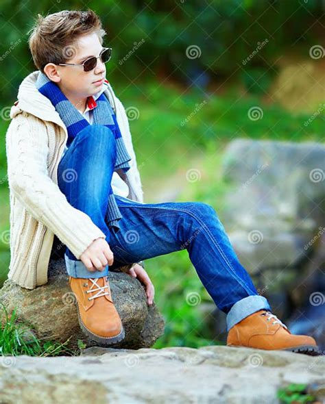 Stylish Teenage Boy Sitting On Rock Outdoors Stock Image Image Of
