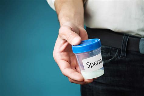 container with sperm in a man s hand concept of donating sperm and testing fertility american