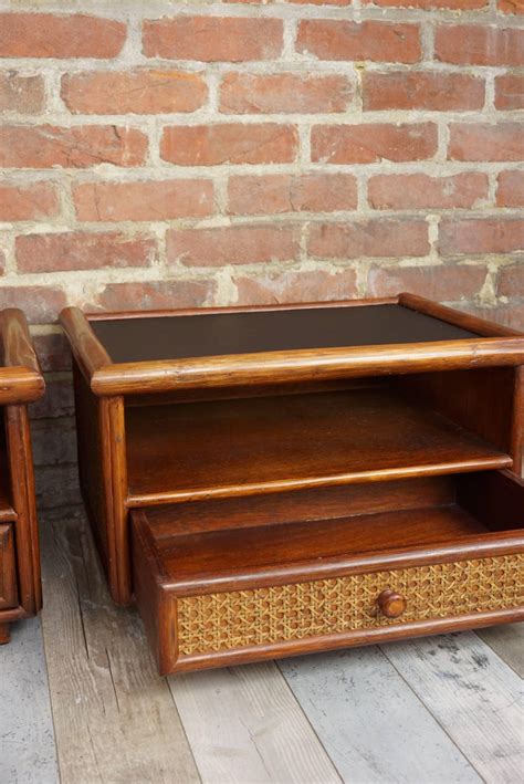 Bedside table in meranti wood and mdf with a drawer that has a rattan front. Pair of Rattan and Cane Bedside Tables For Sale at 1stdibs