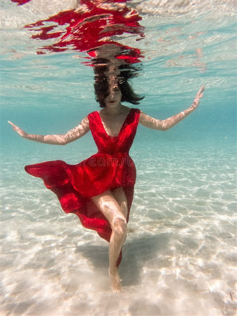 Mystical Underwater Portrait Of Beautiful Asian Young Woman In Red