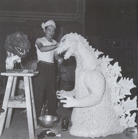 An Old Black And White Photo Of A Person With A Fake Dragon In Front Of Him