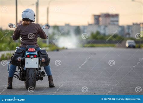 woman motorcyclist waiting train at railroad station travel under own power after bike freight