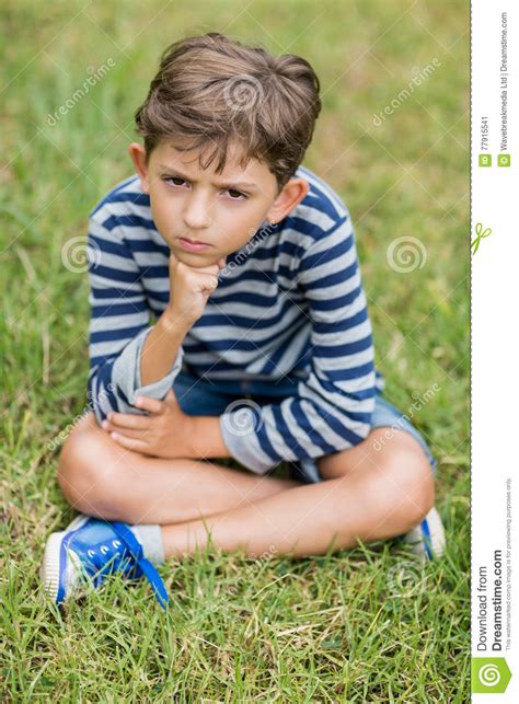 Upset Boy Sitting On Grass Stock Image Image Of Lonely