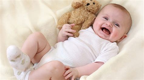 Smiley Cute Infant Is Lying Down On White Cloth With Toy Hd Cute