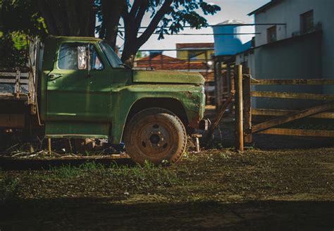 Old Pickup Truck Parked On Yard Near House · Free Stock Photo