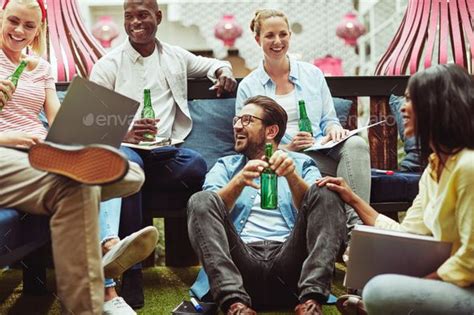 Diverse Businesspeople Drinking Beers After Work In An Office Lounge