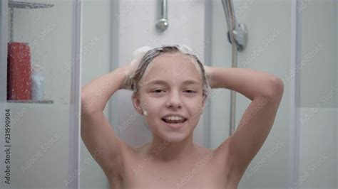Stockvideo Smiling Young Girl Bathing Under A Shower At Home Beautiful