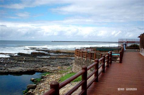 A Wooden Walkway Next To The Ocean