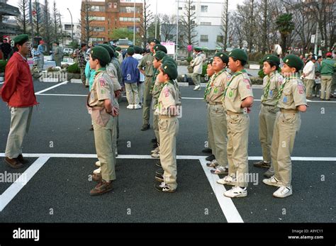 Japanese Boy Scouts Stand At Ease In Preparation For A Parade In Stock