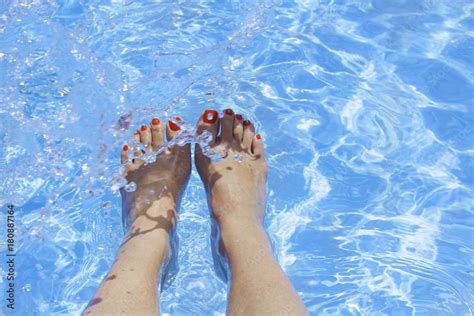 Womans Feet In A Swimming Pool Under Water Beautiful Feet With Red