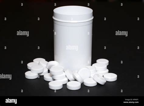 White pills, medicines painkiller. Medications on a black background