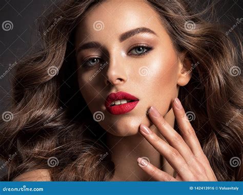 Beautiful Face Of An Attractive Model With Red Lipstick Stock Photo