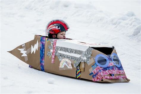 Children Race Cardboard Sleds At City Forest