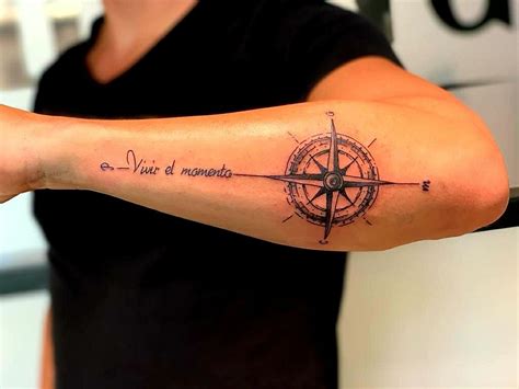 A Person With A Tattoo On Their Arm That Has A Compass And Words