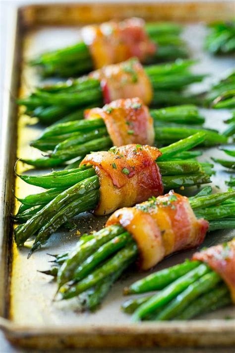 Want to create a traditional christmas dinner menu this year? A row of green bean bundles on a pan. | Thanksgiving food ...